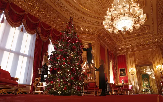 Staff decorate one of the Queen's huge trees