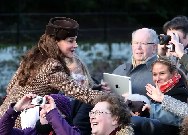 Catherine, Duchess of Cambridge meets members of the public as they leave the Christmas Day Service at Sandringham Church in 2015