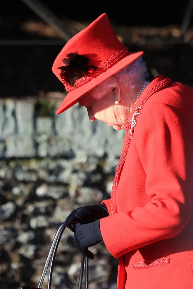 The Queen looked festive in a red ensemble
