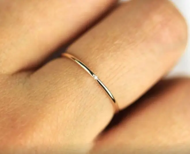 The minimal ring features a tiny diamond