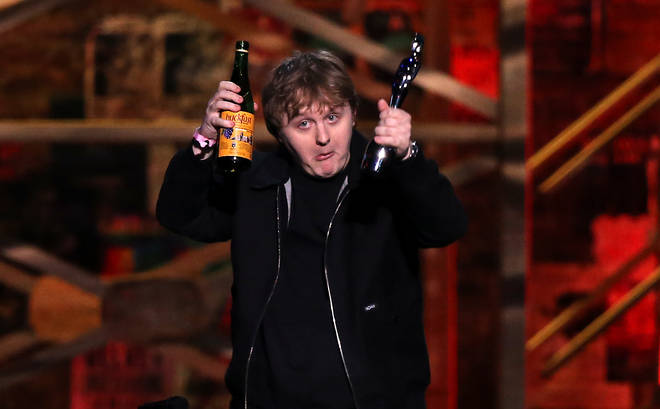 The star brought a bottle of Buckfast to the stage to accept his award for the song