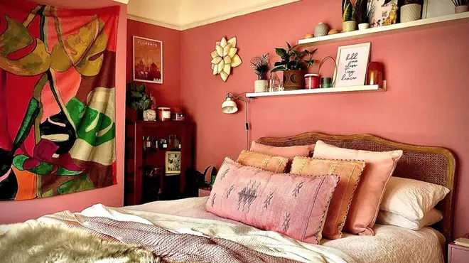 The bedroom features a warm, pink colour scheme