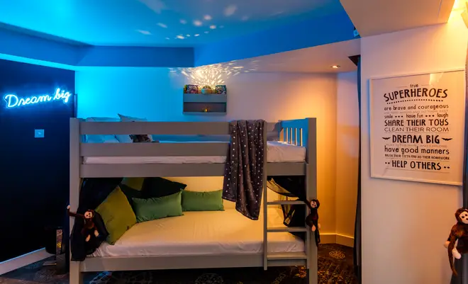 The kids' room has bunk beds and a projector that illuminates the room.