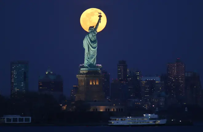 The worm moon lit up New York City and the Statue Of Liberty on Monday night
