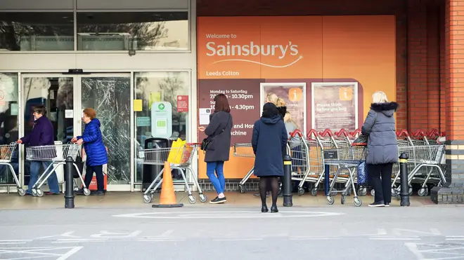 Sainsbury's observing a two-metre distance while queuing to get into Sainsbury's