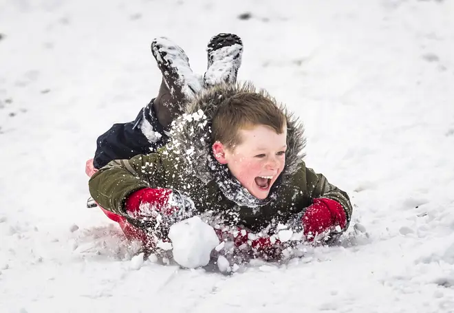 A boy enjoys the snow in the UK last year