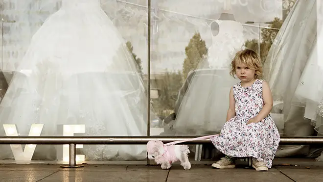 Child waiting outside shop