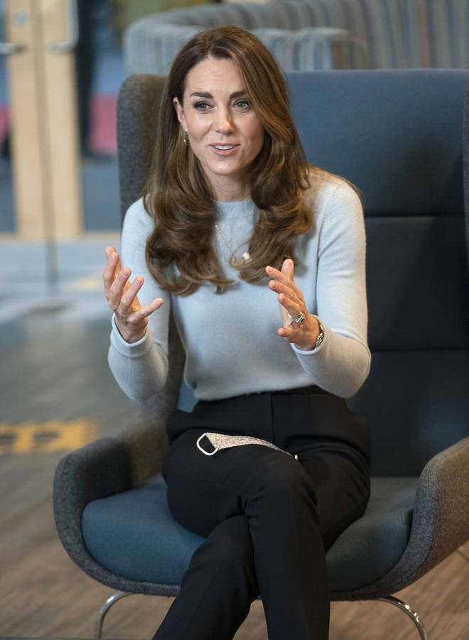 The Duchess of Cambridge wore a blue jumper teamed with black trousers for the outing
