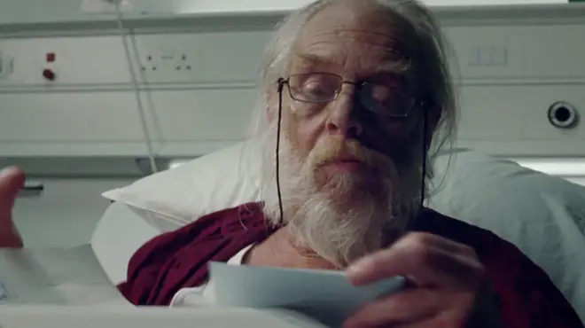 Santa can be seen writing Christmas letters at his hospital bed