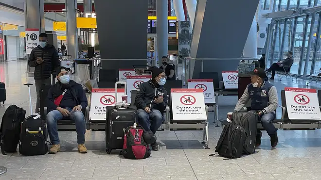 Travellers seen waiting at Heathrow airport