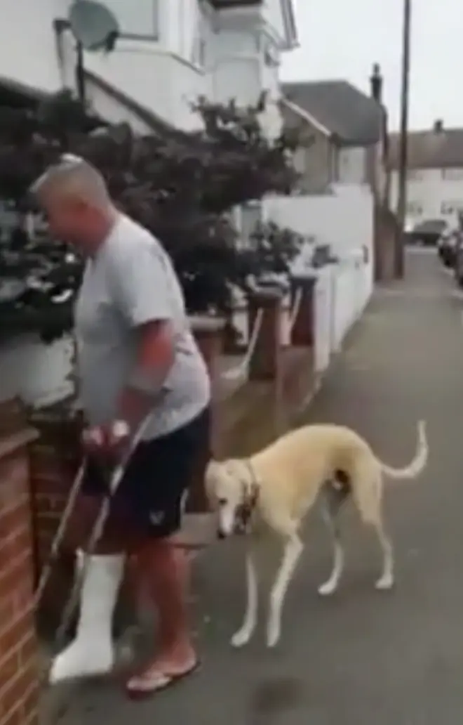 Billy can be seen limping next to his owner, who had broken his ankle