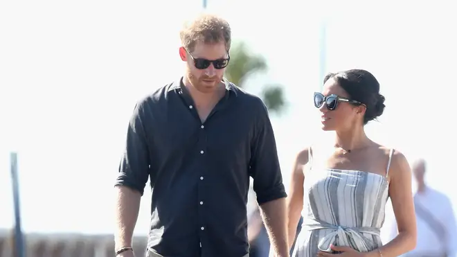 Prince Harry and Meghan Markle holding hands on on royal tour