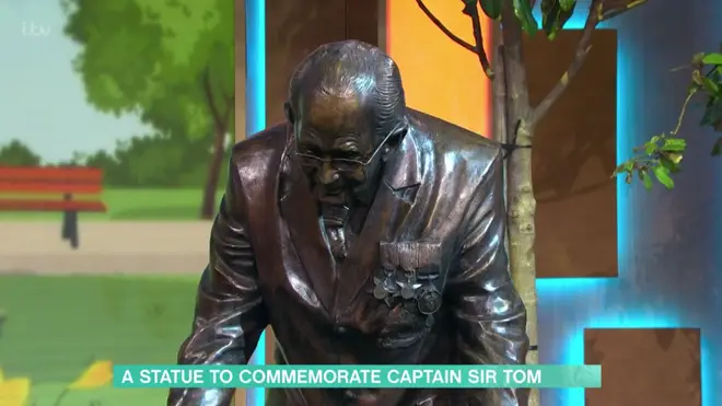 The bronze statue is life-size and shows Sir Tom walking laps of his garden