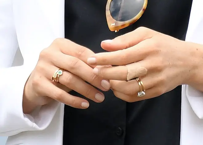 Meghan's stacked rings could signify an April due date