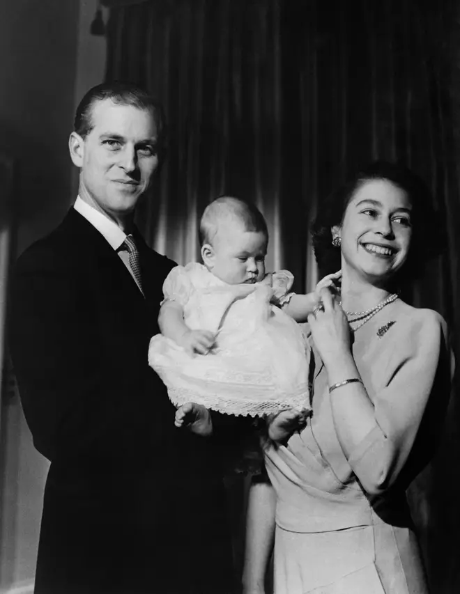 Prince Philip and the Queen pose with their son Prince Charles in 1949
