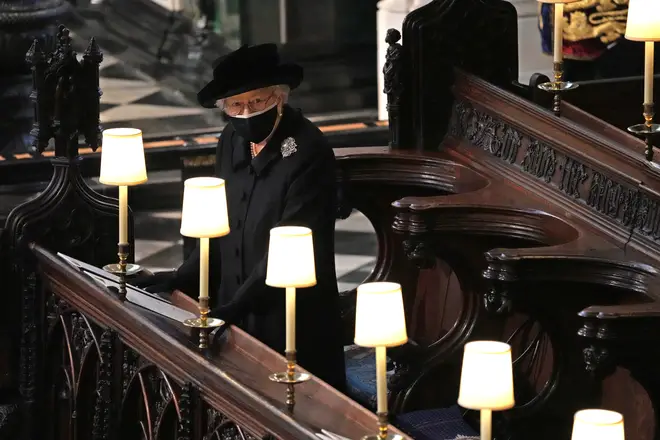 The Queen watches as Prince Philip's coffin enters St George's Chapel