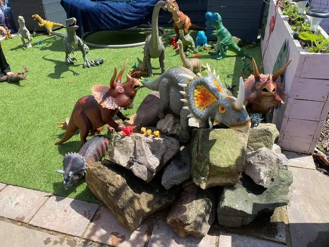 The garden contains an assortment of dinosaur toys