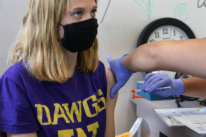 A 14-year-old receives the vaccine in Washington, USA