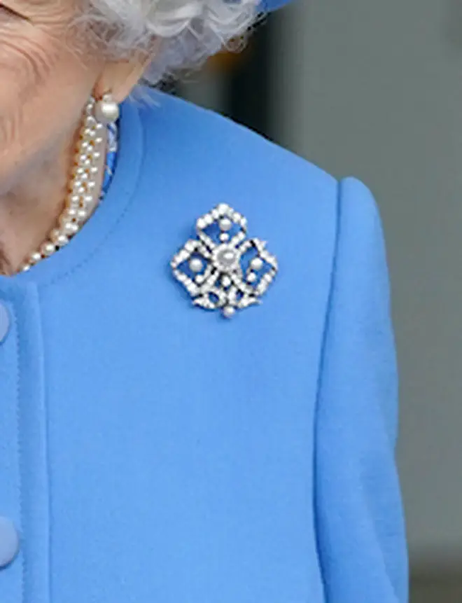 The Pearl Trefoil Brooch is in the shape of the 'trinity knot' and is made up of diamonds and five pearls