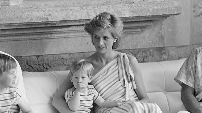 Diana holds Harry while visiting Majorca in 1986