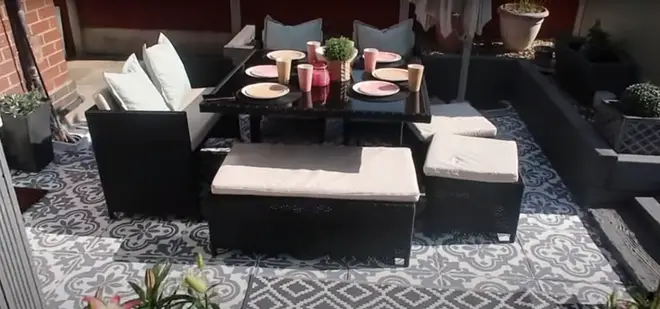 The garden features gorgeous rattan outdoor furniture
