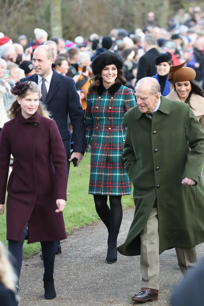 Kate and William hold hands as they walk to a Christmas Day Church Service together