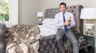 Peter Andre sits on one of the new beds he has designed