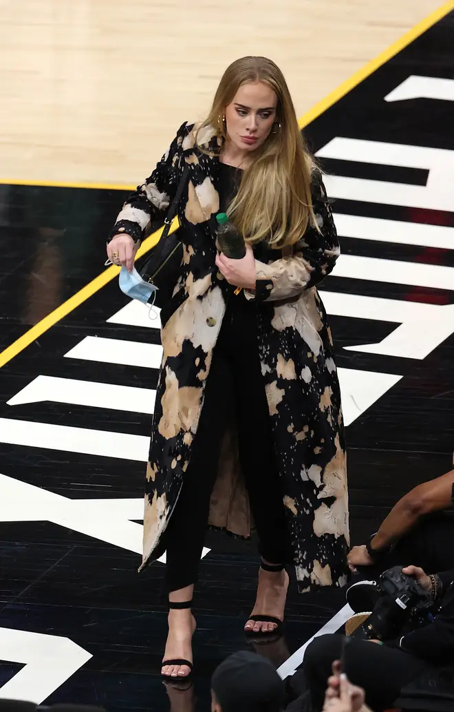 Adele wore black trousers teamed with a black top, black stilettos and a statement jacket
