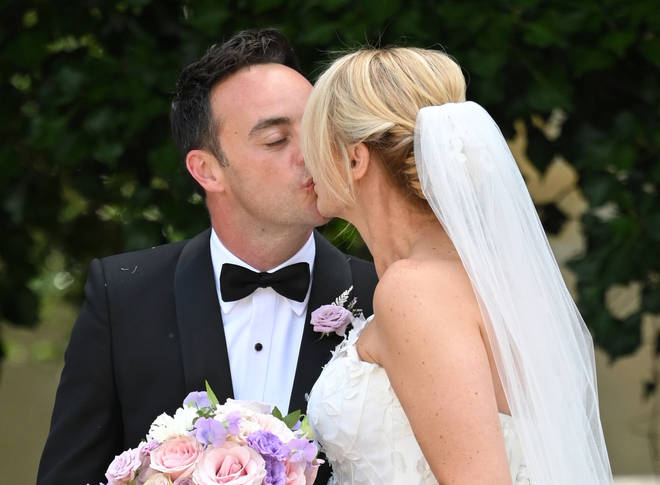 Ant McPartlin and his new wife Anne-Marie share a kiss outside the church following the ceremony