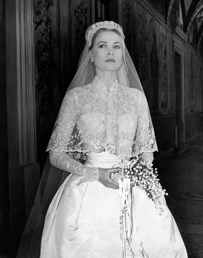 Grace Kelly poses in her wedding gown in 1956