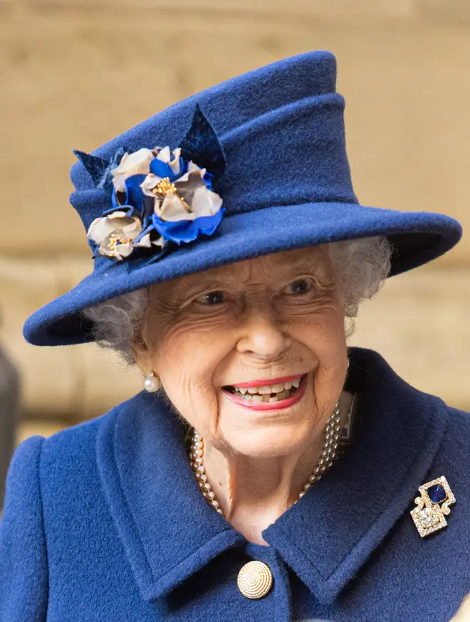 Her Majesty dressed in a blue coat and matching hat for the occasion