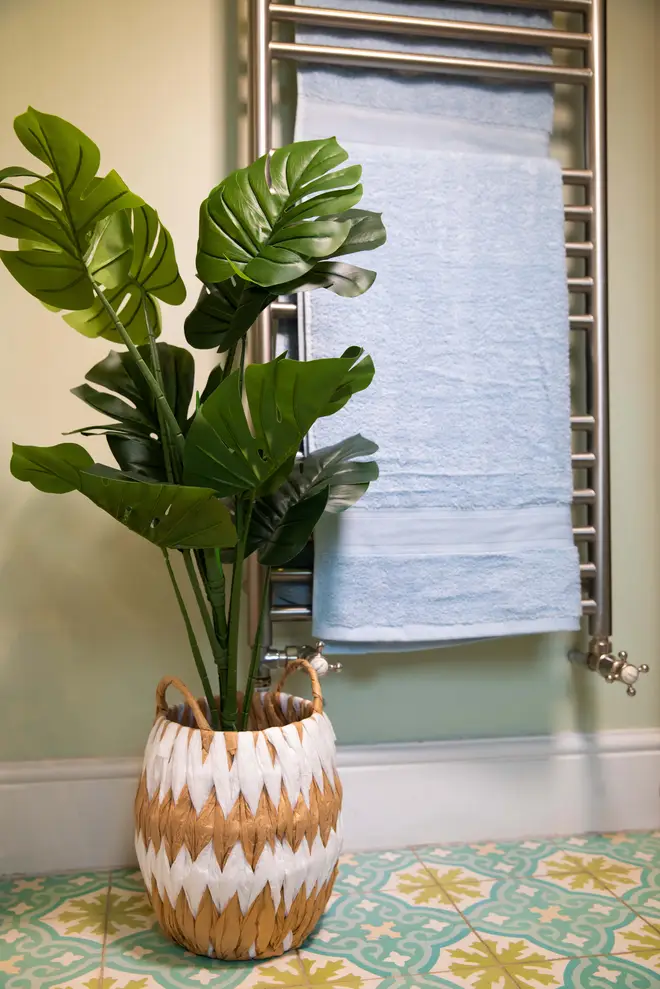 A fake plant is a simple way to brighten up a bathroom