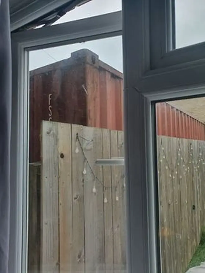 The shipping container can be seen from the next door neighbour's garden