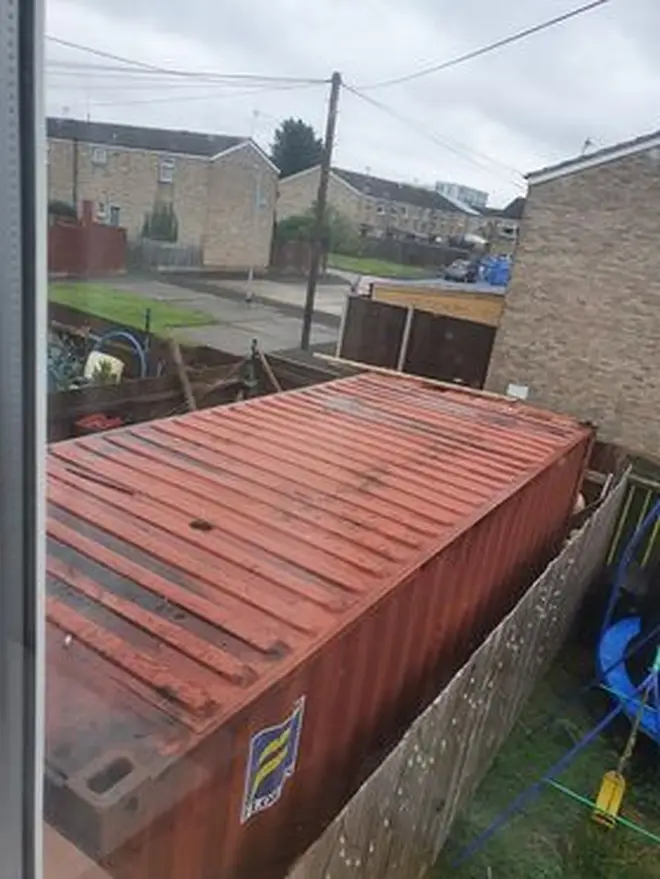 The shipping container takes up the whole garden