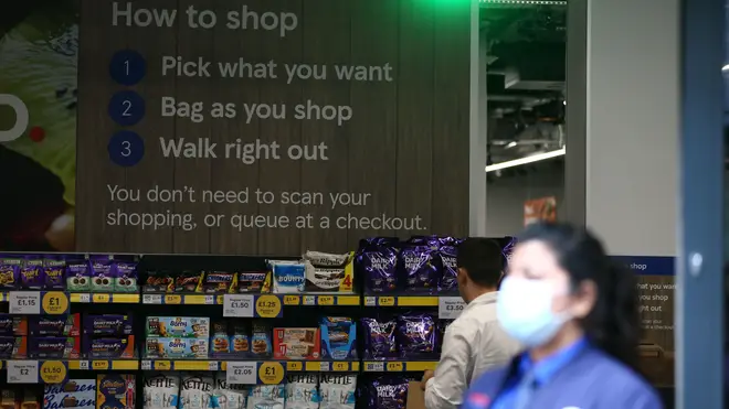Customers use an app to pay for their groceries
