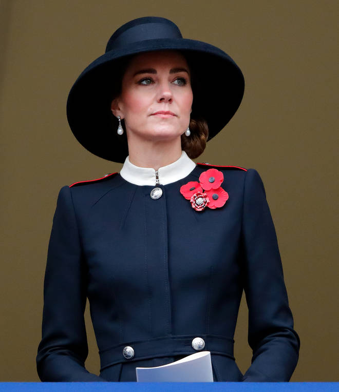 The Duchess of Cambridge looked sombre as she stood in the place of the Queen on the balcony