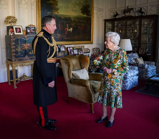 Her Majesty dressed in a floral dress for the meeting, which she stood for unaided despite spraining her back