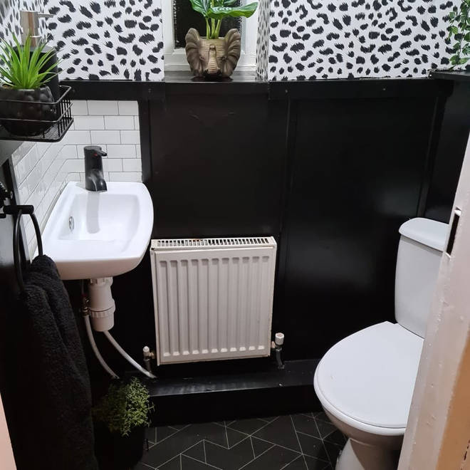 The finished WC, with Dalmatian wallpaper and smart black accessories