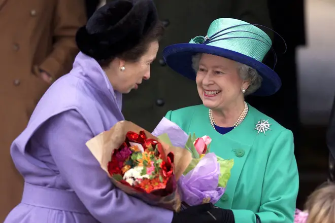 Princess Anna and the Queen hold flowers fro well wishers