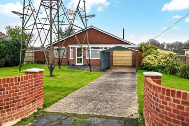 The home comes complete with an electricity pylon in the front garden