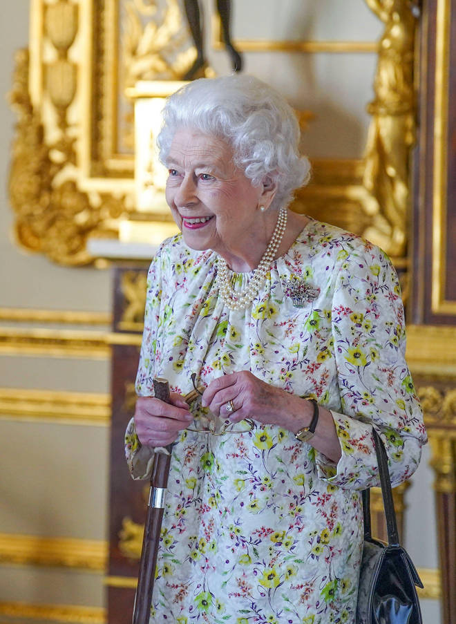 The Queen wore a floral dress, her three-string pearl necklace and The Flower Basket Brooch