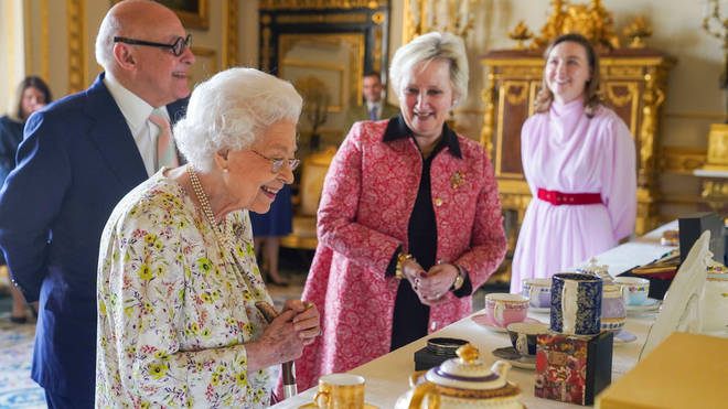 Her Majesty viewed a selection of hand-decorated archive enamelware and fine bone china to commemorate the company's 70th anniversary
