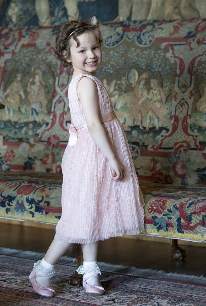 Mila Sneddon dressed in a pink dress for her meeting with Kate Middleton