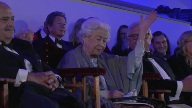 The Queen shrugged the joke off, gesturing a wave to the crowd