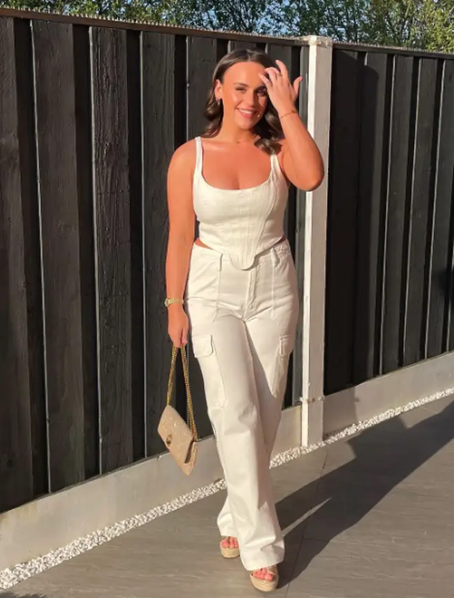 Ellie Leach posing in an all-white outfit