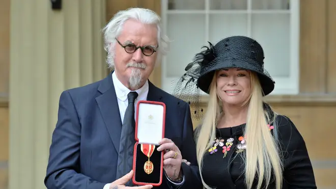 Billy Connolly and wife Pamela Stephenson after he was knighted by the Duke of Cambridge at Buckingham Palace