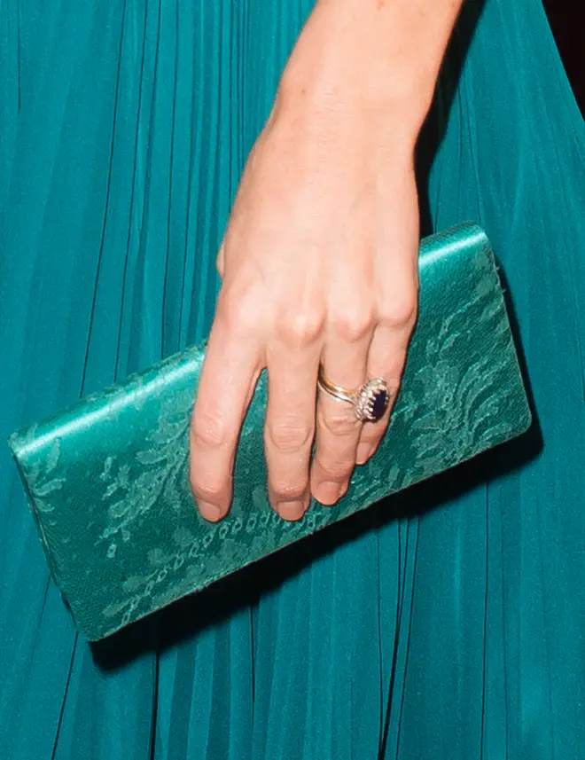 Upon close inspection it's clear to see Kate wears three rings on her wedding finger