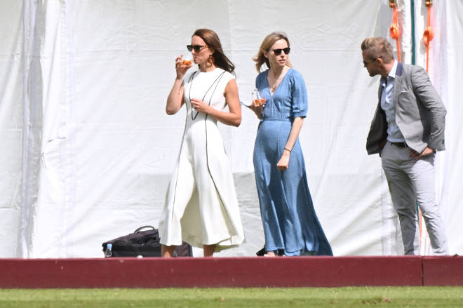 The Duchess of Cambridge teamed her white dress with heeled sandals, sunglasses and hoop earrings