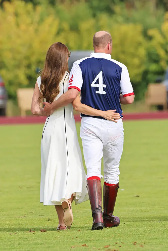 Prince William and Kate Middleton were pictured walking across the pitch with their arms around one another