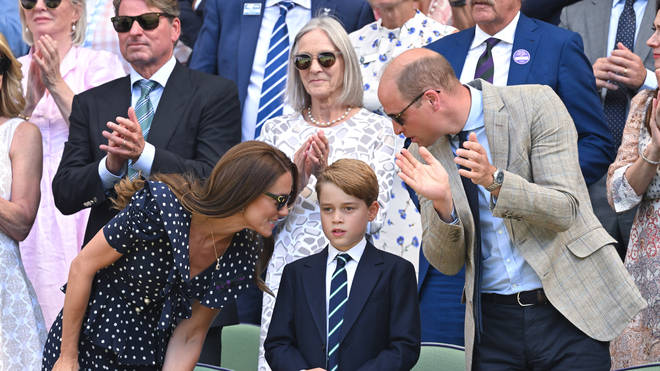 Prince George wore a navy suit to watch the tennis, but was spotted complaining about the heat